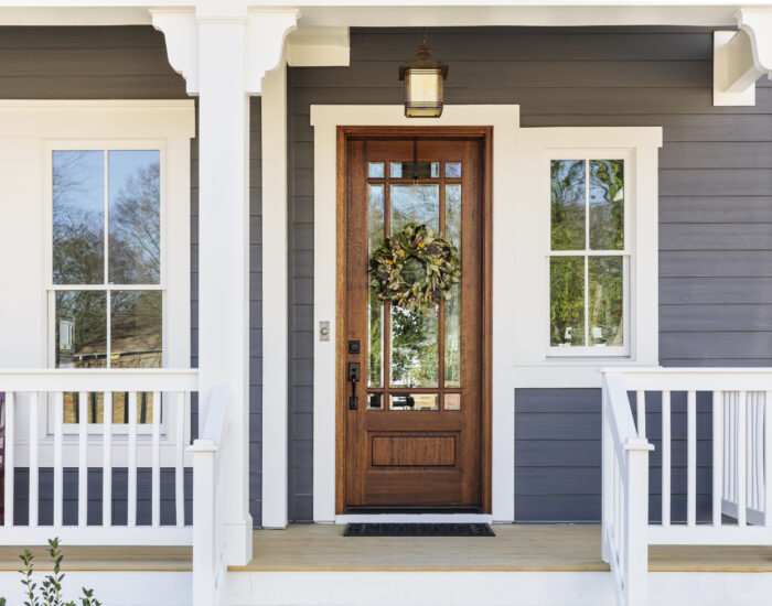 beautiful front porch with white railing on a home