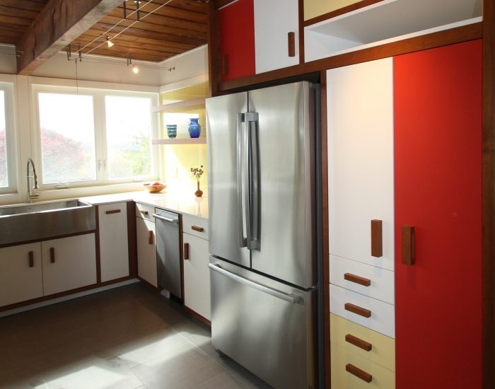 view of fridge and kitchen cabinets