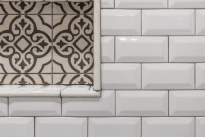 close up of white shower tile on walls