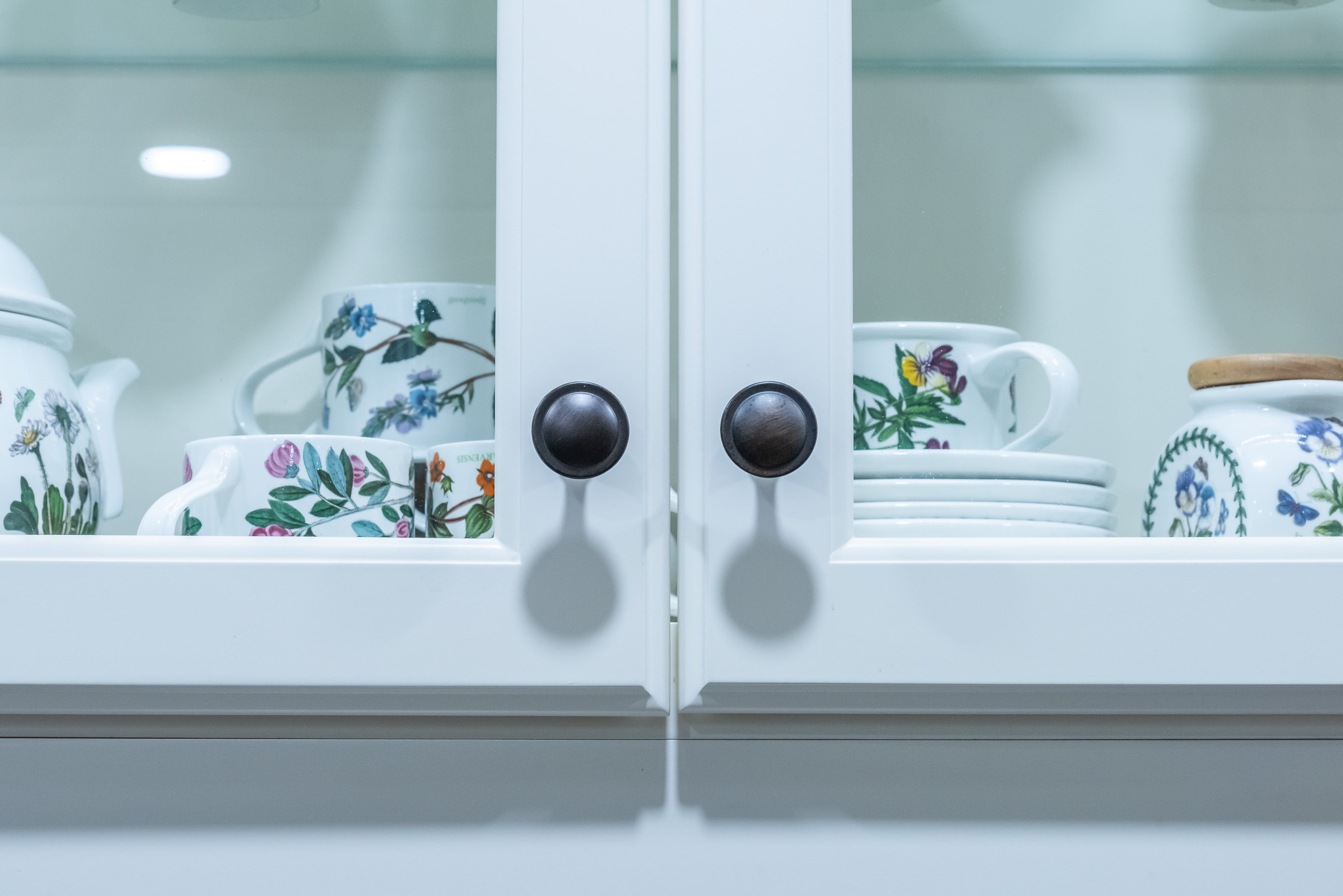 close up of white cabinet storing china