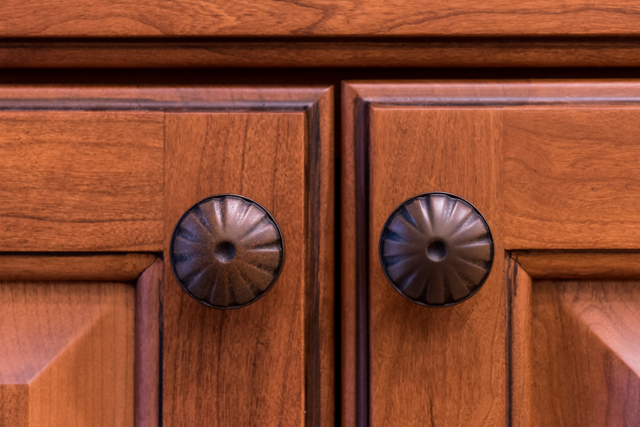 close up of wooden cabinets with swirled knobs