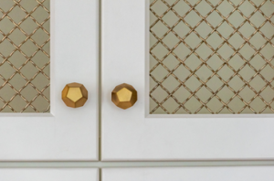 close up of gold knobs on cabinets