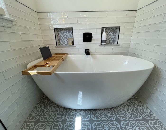 white porcelain tub with wooden tray