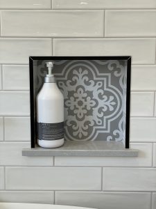 shower feature with patterned opening for holding shower products
