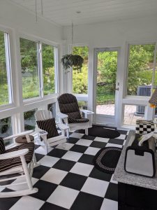 sun room with rocking chairs and black and white checkered floors