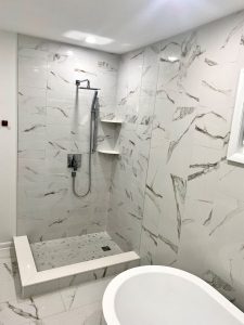 white and grey marbled walls in remodeled bathroom