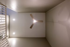 upward view of ceiling fan and newly painted ceiling and walls in living room