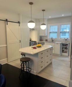beautiful new white kitchen remodel with white marble countertops and cabinets