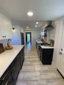 chatham, ny kitchen remodel with tan tile, navy blue cabinets, and white countertops