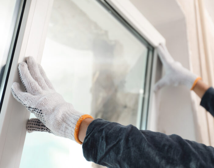 window installation by worker wearing gloves