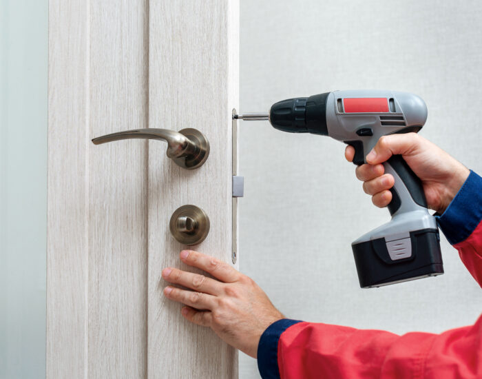 screwdriver inserting into a door during door replacement