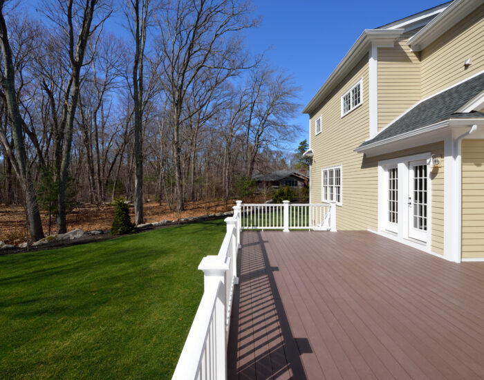 large deck remodel on tan home