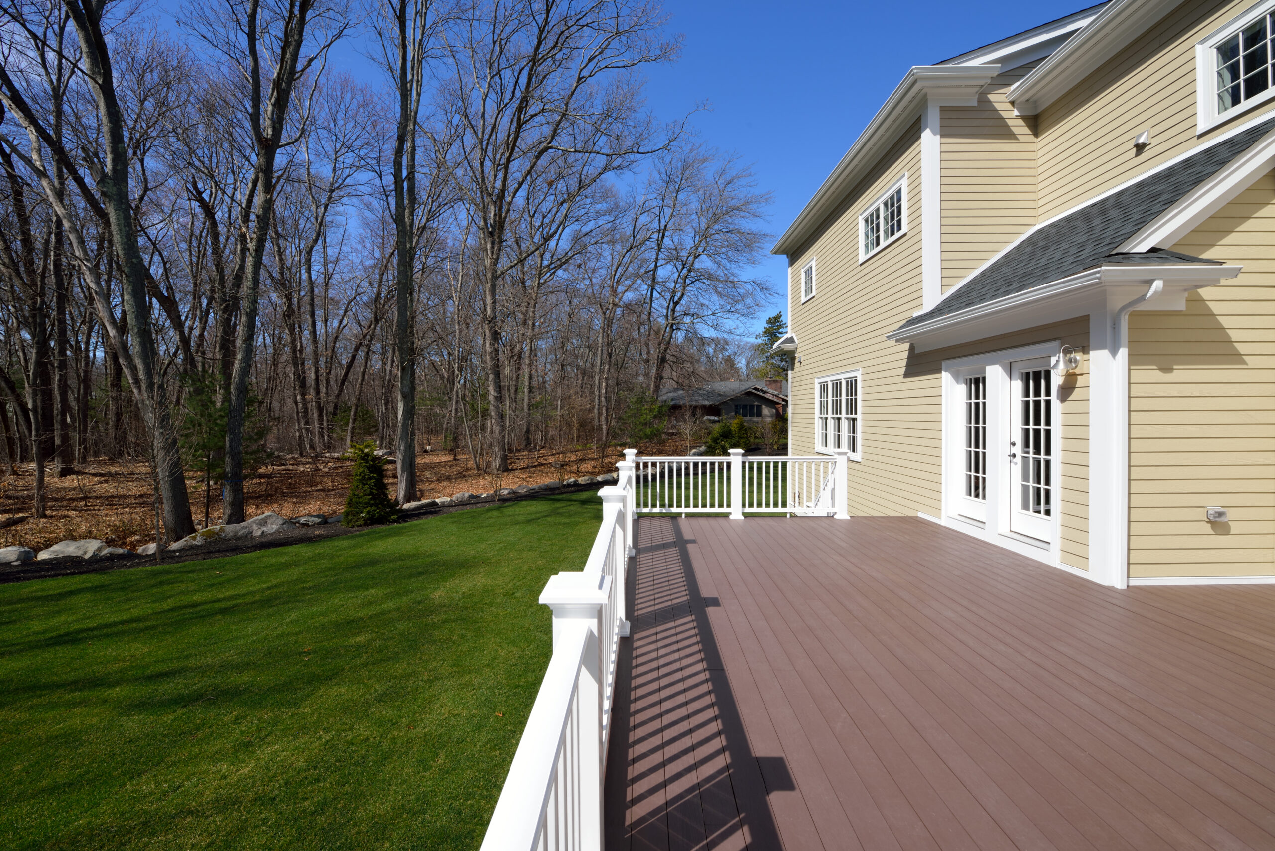 large deck remodel on tan home